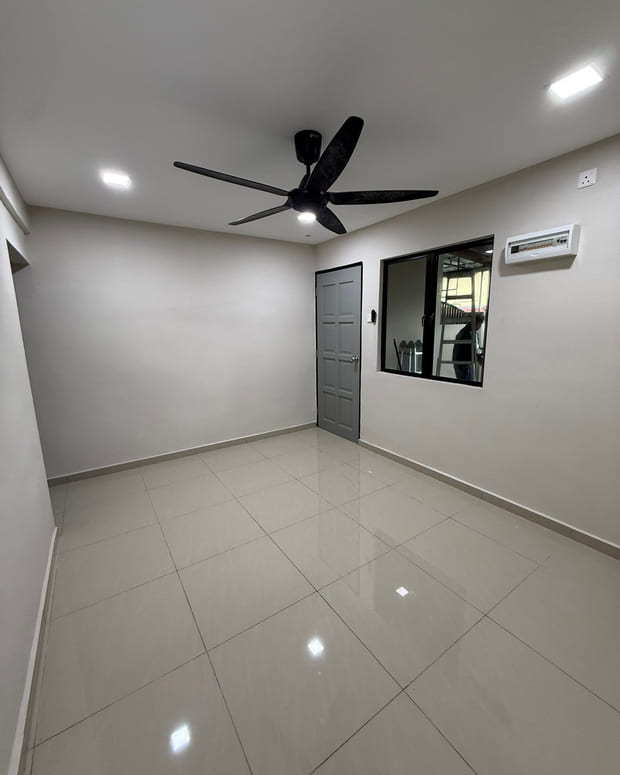 A completed room with fresh white walls, a new grey panelled door, a black ceiling fan with an integrated light and large gloss cream floor tiles.